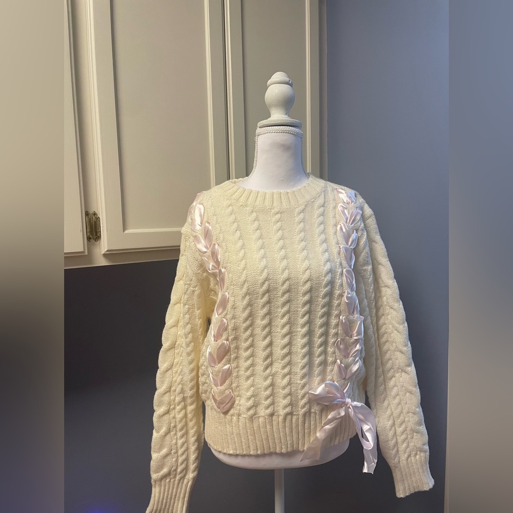 Elegant Cream Cable Knit Sweater with Pink Ribbon Accents